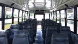 2014 Freightliner Thomas Diesel bus interior with rows of black vinyl seats and overhead lighting