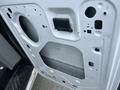 A 2009 Ford Econoline door panel showing the interior side with cutouts and a latch mechanism visible