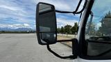 A side mirror of a 2018 Mitsubishi Fuso FE truck reflecting a clear view of the surroundings