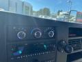 Dashboard controls of a 2020 Chevrolet Express showing knobs for air conditioning and audio system