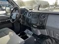 Interior view of a 2011 Ford F-450 Super Duty showing the dashboard seats and center console with various controls and accessories