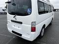 A white 2002 Nissan Van with a rear disability access sticker and a clean, simple design showcasing its rear view