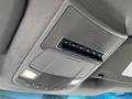 The overhead console of a 2017 Ford F-250 SD featuring several auxiliary switches and control buttons along with overhead lights