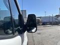 A 2016 Ford Transit van showcasing its side mirror with the vehicle body visible in the foreground