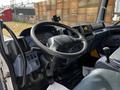 Interior view of a 2006 Hino 268 truck showing the steering wheel dashboard and control panel