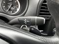 Close-up of a gear shift lever from a 2020 Mercedes-Benz Metris with indicators for reverse neutral and drive along with plus and minus symbols