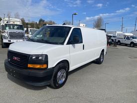 White 2022 GMC Savana cargo van with black details and chrome wheels parked at an outdoor lot