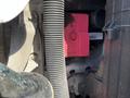 A close-up view of a pink control box labeled Daimler mounted within the engine compartment of a 2022 Freightliner Cascadia