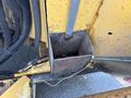 A close-up of a rusty metal compartment on a 2015 Vermeer Corporation BC1200XL with visible wires and connectors nearby