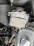 A close-up view of the alternator from a 1970 Chevrolet Corvette with electrical wires and components visible attached to it