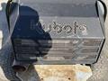 Close-up of a 2010 Kubota F3990 engine cover with the Kubota logo and perforated design showcasing the engine underneath