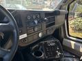 Interior view of a 2017 Chevrolet Express showing the dashboard with controls audio system and various buttons on the console