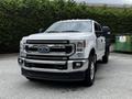 A 2020 Ford F-350 Super Duty truck in white with chrome accents and a clean front grille showcasing the Ford logo