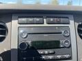 The dashboard of a 2013 Ford Expedition featuring a radio display with buttons for navigation and audio controls