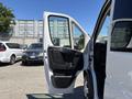 A 2016 RAM Promaster with the front passenger door open showcasing the interior and seating details