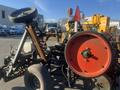 A 2017 R&R Reel featuring large wheels a red drum and various metal components for equipment operation