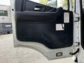 Interior door panel of a 2012 Autocar Xpert featuring a smooth design with a handle and multiple warning labels