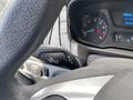 Close-up of the steering wheel controls in a 2019 Ford Transit showing turn signal and headlight options