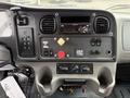 Dashboard of a 2005 Freightliner M2 106 featuring controls for audio, climate, and various electronic systems