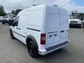 White 2013 Ford Transit Connect van with a cargo area and black wheels viewed from the rear angle