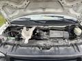 A 2014 GMC Savana with its hood open revealing the engine compartment and various components such as the air intake and battery