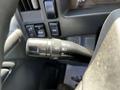 Close-up of the turn signal and cruise control lever of a 2016 Isuzu NPR located on the steering column