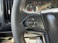 A steering wheel with controls for cruise control settings in a 2017 GMC Sierra 3500HD