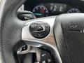 Close-up view of the steering wheel controls of a 2019 Ford Transit Connect featuring a dial with directional arrows and an "OK" button
