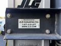 Label on a JLG 12SP lift featuring the manufacturer's name JLG Industries Inc and contact information