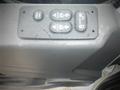 Control panel for windows and doors on a 2017 International 4300 featuring buttons for window operation and door locking