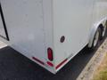 A white 2004 Royal 18-foot office trailer viewed from the rear featuring two wheels and red tail lights