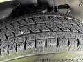 Close-up of a tire from a 2013 Chevrolet Express showing a detailed tread pattern designed for improved traction on various surfaces