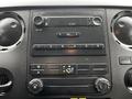 Dashboard of a 2011 Ford F-550 featuring audio controls knobs and a digital display