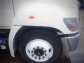 A white 2014 Hino 308 truck with a clear view of the front wheel and tire along with a side orange marker light