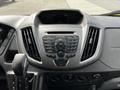 Dashboard of a 2018 Ford Transit featuring controls for radio and media with a display screen above and various climate and power buttons below