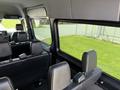 Interior view of a 2019 Mercedes-Benz Sprinter showing black leather seats and spacious design with large windows