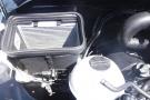 A 2012 Mercedes-Benz Sprinter engine compartment showing the air filter housing fluid reservoir and various engine components