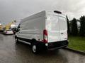 A 2020 Ford Transit van in white with a rear view showing its large cargo area and smooth lines