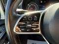 The steering wheel controls of a 2023 Mercedes-Benz Sprinter featuring buttons for cruise control and driver assistance systems