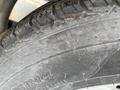 Close-up of a tire on a 2011 Hightliner Aquacide Hot Water Weed Control Dual Flat Deck Trailer showing tread pattern and size specifications
