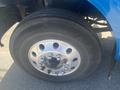 A close-up of a wheel from a blue 2008 Peterbilt 340 featuring a silver rim and a large black tire with the number S7244 clearly visible