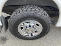 Close-up of a chrome wheel rim with a large, rugged tire mounted on a 2012 GMC Savana