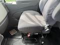 A gray upholstered driver's seat in a 2011 International 4300 with a lever for height adjustment visible on the side