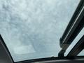 A panoramic sunroof of a 2015 Kia Sorento showing a view of the cloudy sky