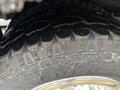 Close-up of a tire from a 2020 Chevrolet Express showing deep tread patterns and slight wear on the rubber surface