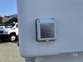 A silver locking fuel door on the side of a 2014 Ford F-350 SD