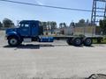 A blue 2008 Peterbilt 340 truck with a flatbed design and dual rear axles is displayed prominently in profile view