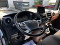 Interior view of a 2021 Hino 338 featuring a steering wheel dashboard digital display and control panels with various buttons and knobs