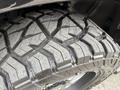 Close-up of a rugged tire from a 2018 RAM 1500 featuring aggressive tread patterns designed for off-road traction