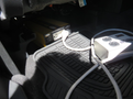 A 2015 Ford Escape with a black floor mat and electronic devices visible on the floor inside the vehicle